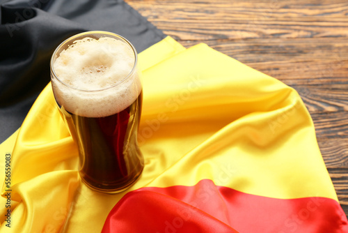 Belgium flag and glass of beer on wooden background photo