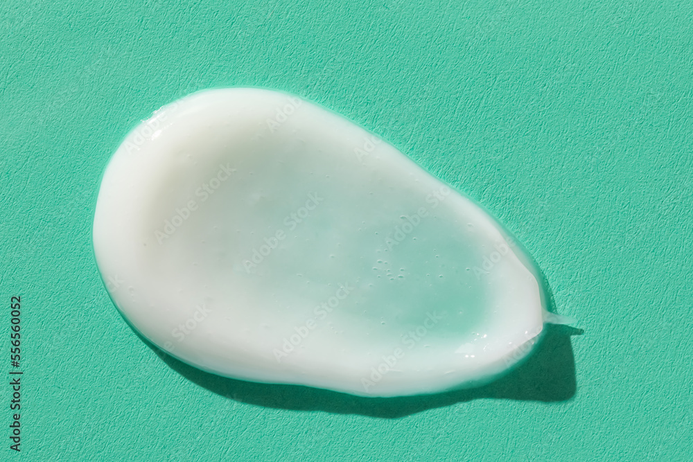 Sample of moisturizing cream on green background Sample of moisturizing cream on green background