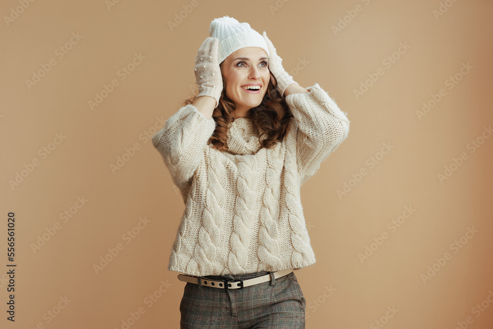 surprised elegant woman on beige background