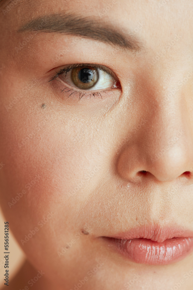 Fototapeta premium Closeup on asian female looking in camera