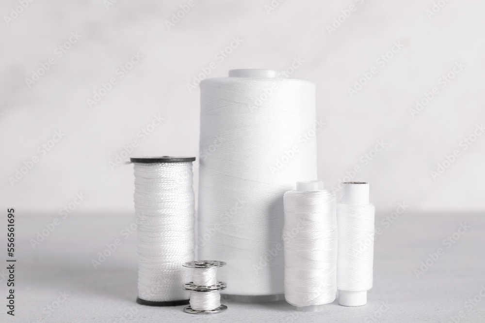 Different thread spools on light background Different thread spools on light background