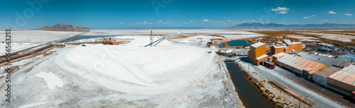Salt Lake City, Utah landscape with desert salt mining factory at lake Bonneville with piles of white mineral and industrial equipment photo