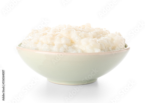Bowl with delicious rice pudding on white background photo