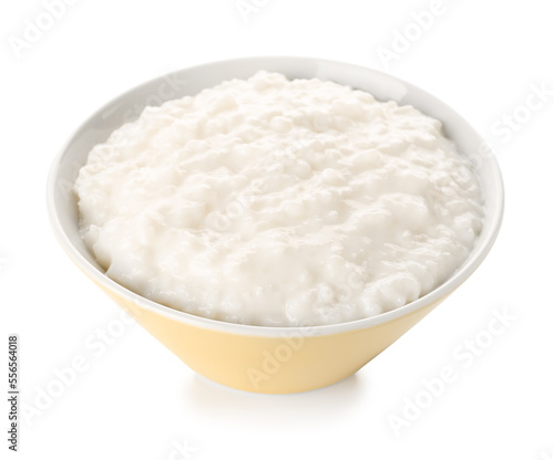 Yellow bowl with delicious rice pudding on white background