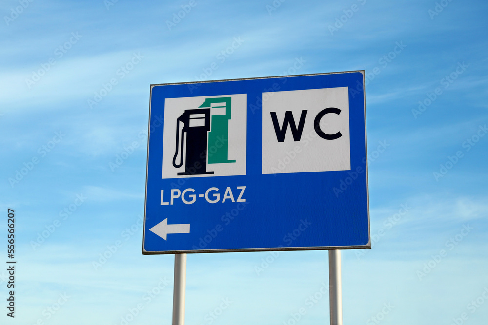 Traffic signs Petrol Station Equipped Only with Gas for Motor Vehicles and Public Toilet outdoors on sunny day Traffic signs Petrol Station Equipped Only with Gas for Motor Vehicles and Public Toilet outdoors on sunny day