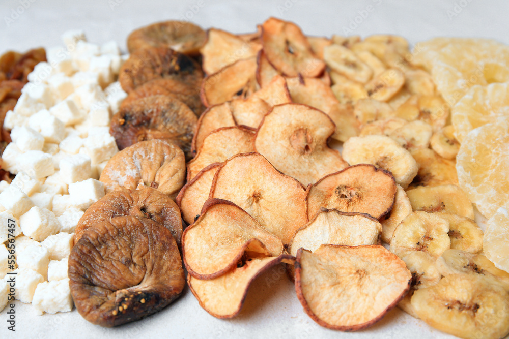 Different tasty dried fruits on paper, closeup Different tasty dried fruits on paper, closeup