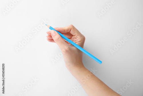 Woman with light blue pencil on white background, closeup