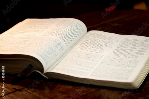 holy bible open on a wooden table