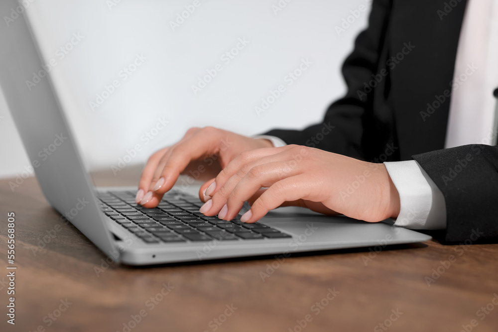 Woman working on laptop at wooden table closeup. Electronic document management Woman working on laptop at wooden table closeup. Electronic document management
