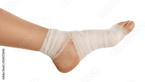 Woman with foot wrapped in medical bandage on white background, closeup