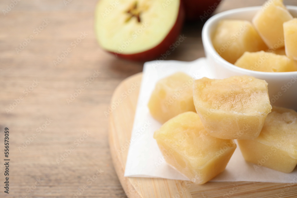 Frozen apple puree cubes and ingredient on wooden table, closeup. Space for text Frozen apple puree cubes and ingredient on wooden table, closeup. Space for text