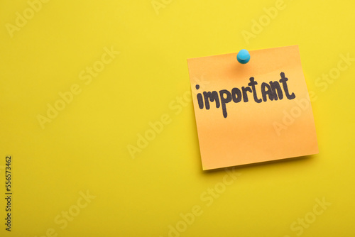 Paper note with word Important pinned on yellow background, space for text
