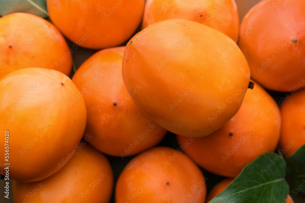 Delicious ripe juicy persimmons as background, top view