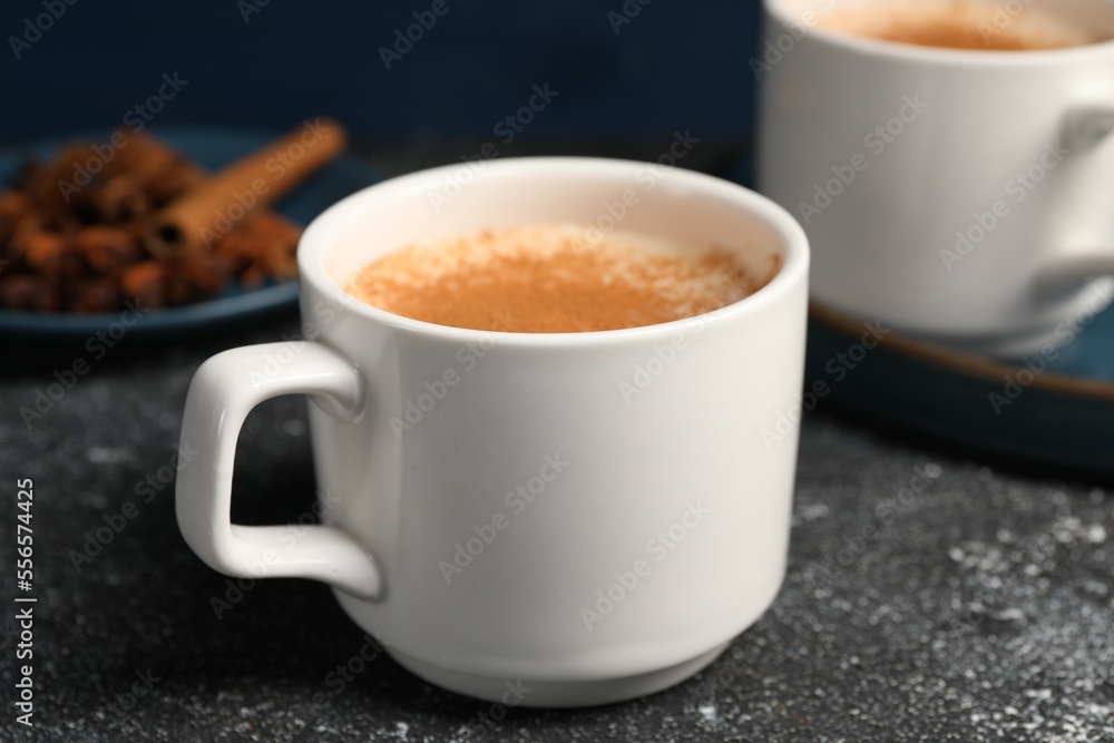 Delicious eggnog with anise and cinnamon on grey table Delicious eggnog with anise and cinnamon on grey table