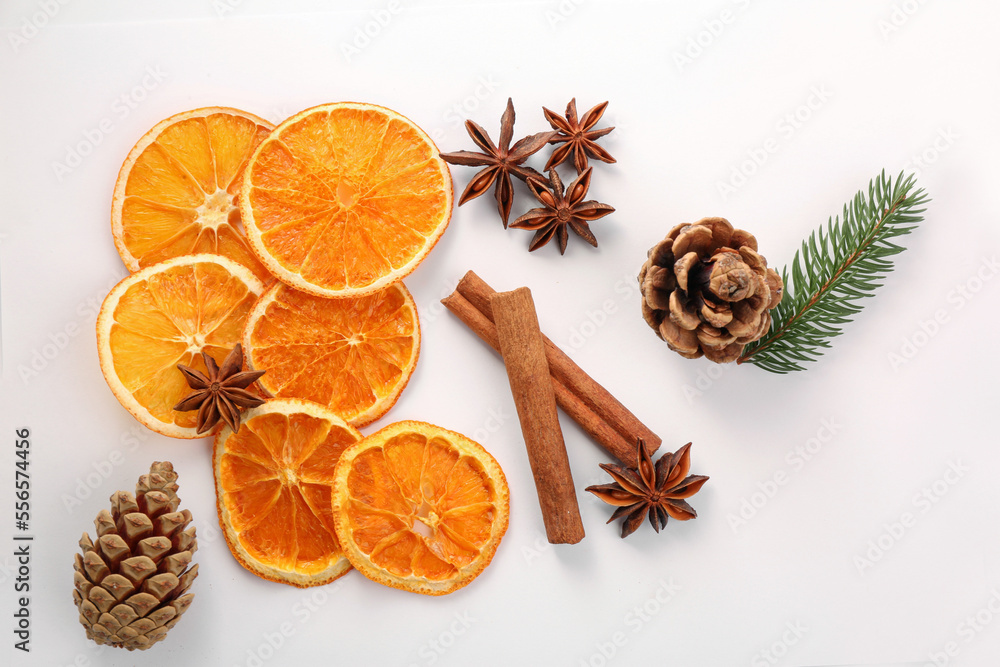 Flat lay composition with dry orange slices, anise stars and cinnamon sticks on white background Flat lay composition with dry orange slices, anise stars and cinnamon sticks on white background