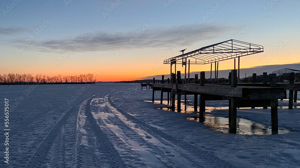 sunrise on the pier with frozen lake