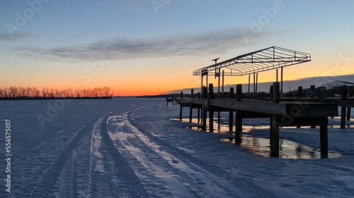 sunrise on the pier with frozen lake