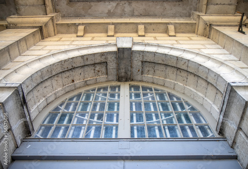 Photos Entrance detail on late 19th century limestone building showing stone archway an