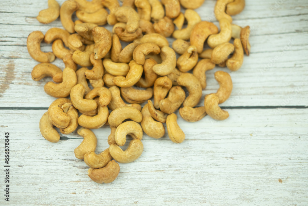 Directly above shot of tasty cashew nuts on wood table. Directly above shot of tasty cashew nuts on wood table.