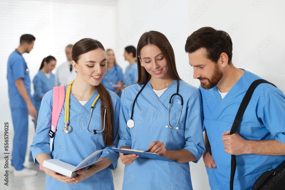 Medical students wearing uniforms in university hallway Medical students wearing uniforms in university hallway