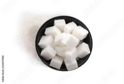 Granulated and cubed sugar with bowl on white background, top view