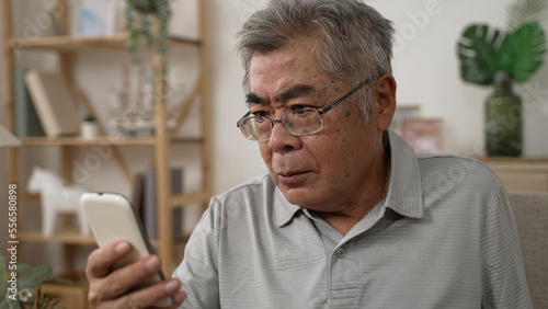 Wallpaper Mural unsatisfied elder aged male in glasses stay at home solve issues distantly use gadget in quarantine. old man having difficult cellphone problems. frowning mature guy concentrated use mobile phone Torontodigital.ca