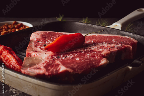 Konstfotografi Carolina reaper pepper over the raw T-bone or porterhouse steak