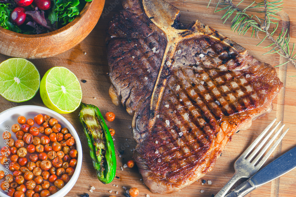 Ταπετσαρία Grilled t-bone or porterhouse steak seasoned with rosemary in a rustic kitchen o