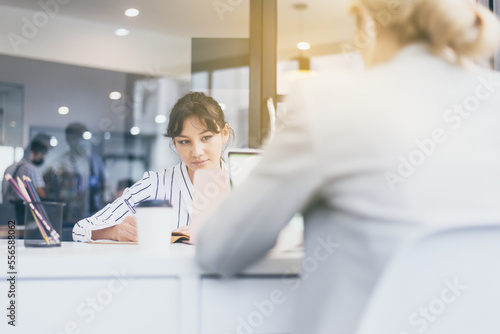Women copywriter in casual suit working for new project at modern office