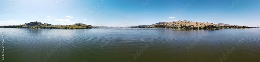 360 degree photography of Overlooking Lake Hume is the picturesque town of Bellbridge, offering views of nearby Bethanga Bridge in Albury NSW, Australia, the calm water shot by drone. 