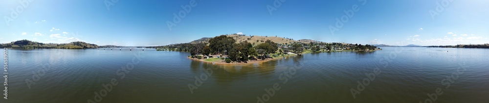 360 degree photography of Overlooking Lake Hume is the picturesque town of Bellbridge, offering views of nearby Bethanga Bridge in Albury NSW, Australia, the calm water shot by drone. 