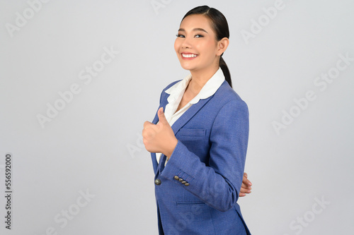 Young beautiful woman in formal clothing for officer with thumb up posture