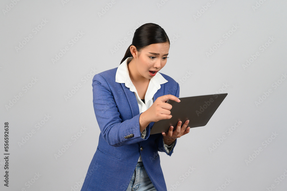 Young beautiful woman in formal clothing for officer holding laptop computer Young beautiful woman in formal clothing for officer holding laptop computer
