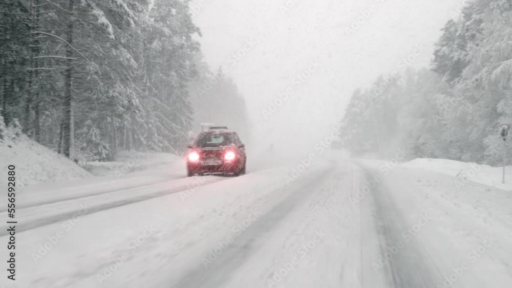 Cars drive in bad driving weather in winter in the snow Cars drive in bad driving weather in winter in the snow