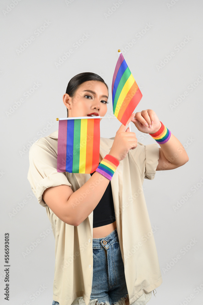 Pretty woman LGBQ pose with mini muli-color flag Pretty woman LGBQ pose with mini muli-color flag