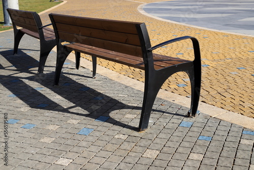 Bench for rest in the city park on the seashore. © shimon