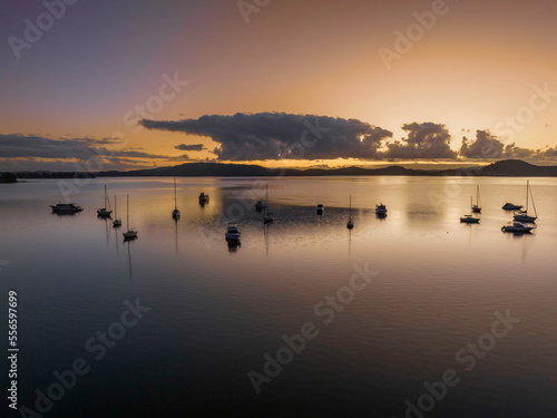 Aerial sunrise waterscape with boats  clouds and reflections