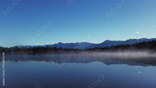 Lake mist with mountains and forest Enid British Columbia Canada photo