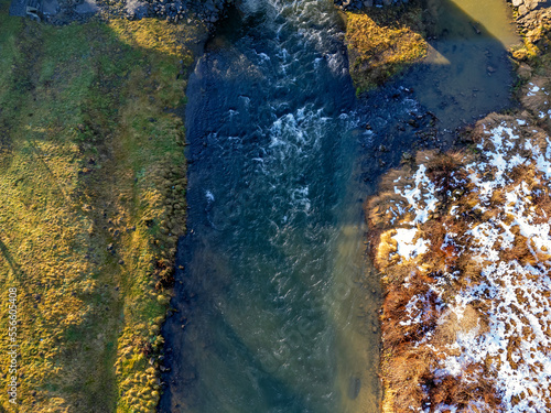 Obraz na płótnie Aerial view. Flowing river, nature, winter, snow, meadow. w salonie