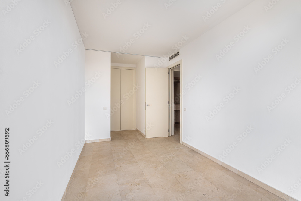 Empty room with tile flooring and newly painted white walls. Repair and construction concept. Empty room with tile flooring and newly painted white walls. Repair and construction concept.