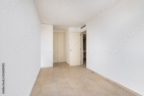 Empty room with tile flooring and newly painted white walls. Repair and construction concept.
