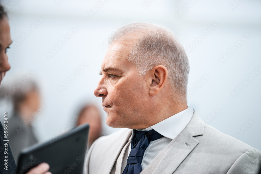 close up. serious business man standing in office. close up. serious business man standing in office.
