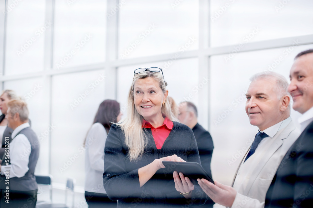 serious employees discussing business document before meeting. serious employees discussing business document before meeting.