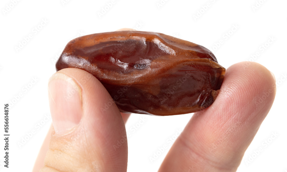 Dried date in hand isolated on white background. Dried date in hand isolated on white background.