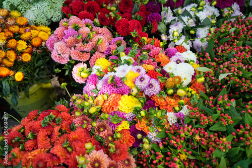 Various flowers are blooming in the jar for sale at the market on summer day