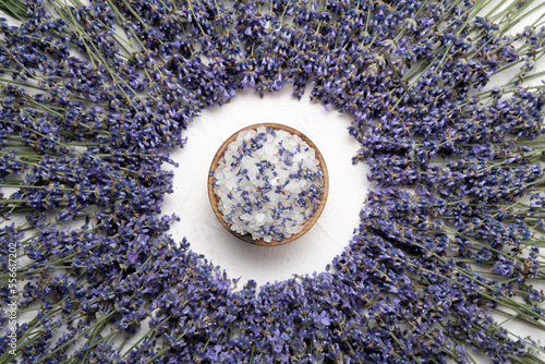 Natural lavender, salt on white concrete background, hygiene items for bath and spa. Flat lay, top view.