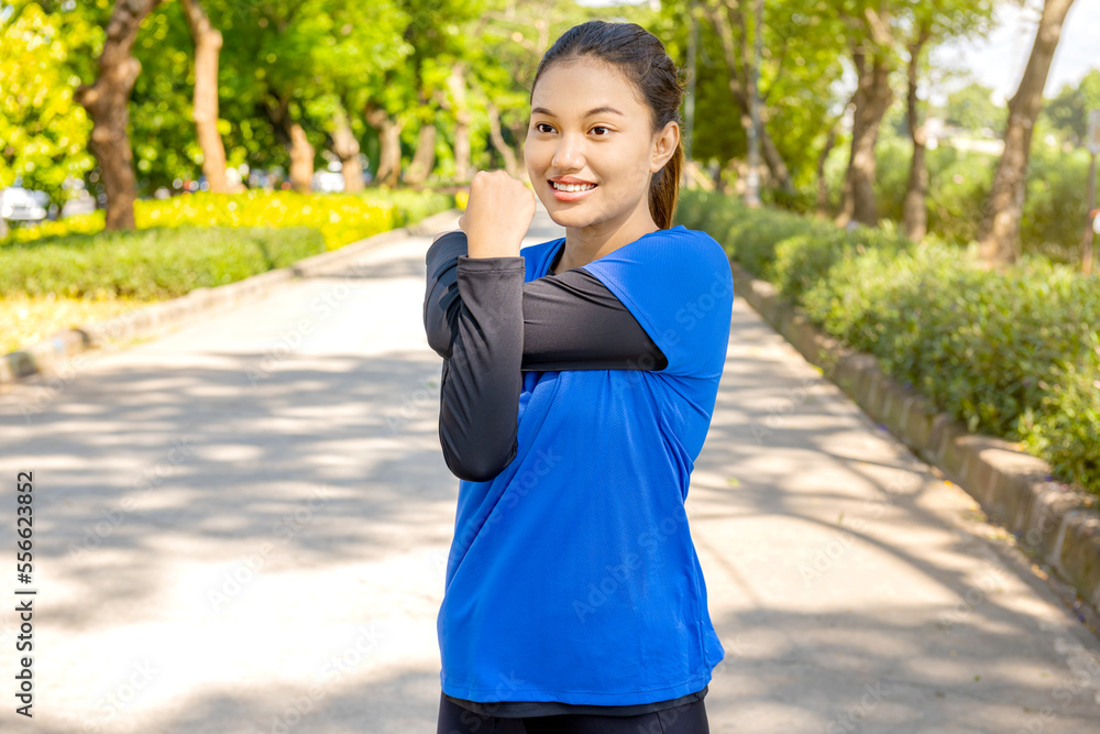 Asian woman stretching her arms before running Asian woman stretching her arms before running