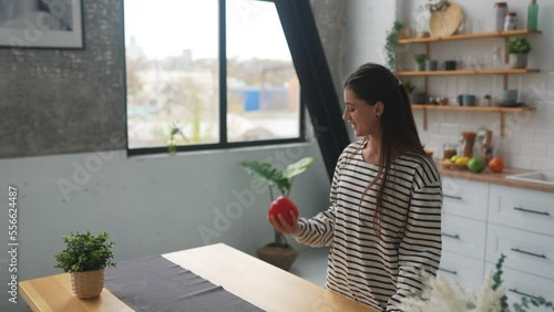 Joyful young woman fooling around in the kitchen having fun
