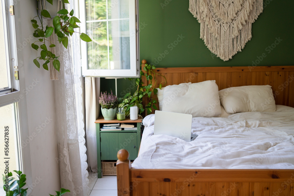 Macrame hanging over bed with laptop in bedroom Stock Photo Adobe Stock