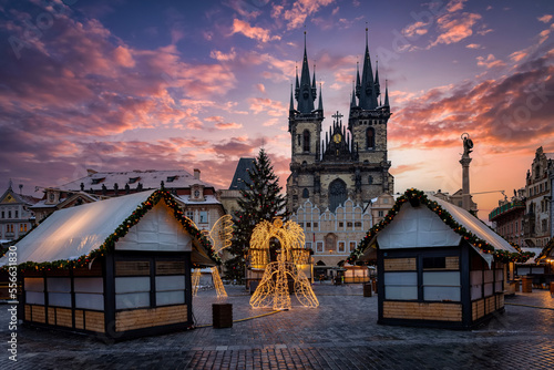 Beautiful winter sunrise view of the old town square of Prague, Czech Republic, with a christmas market and the famous Tyn Church